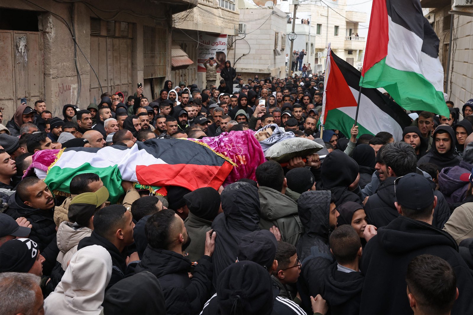 Large funeral for Palestinian youth killed by Israeli troops in West Bank; Two GOP senators join calls for Kristi Noem's resignation; Ilhan Omar attacked at town hall